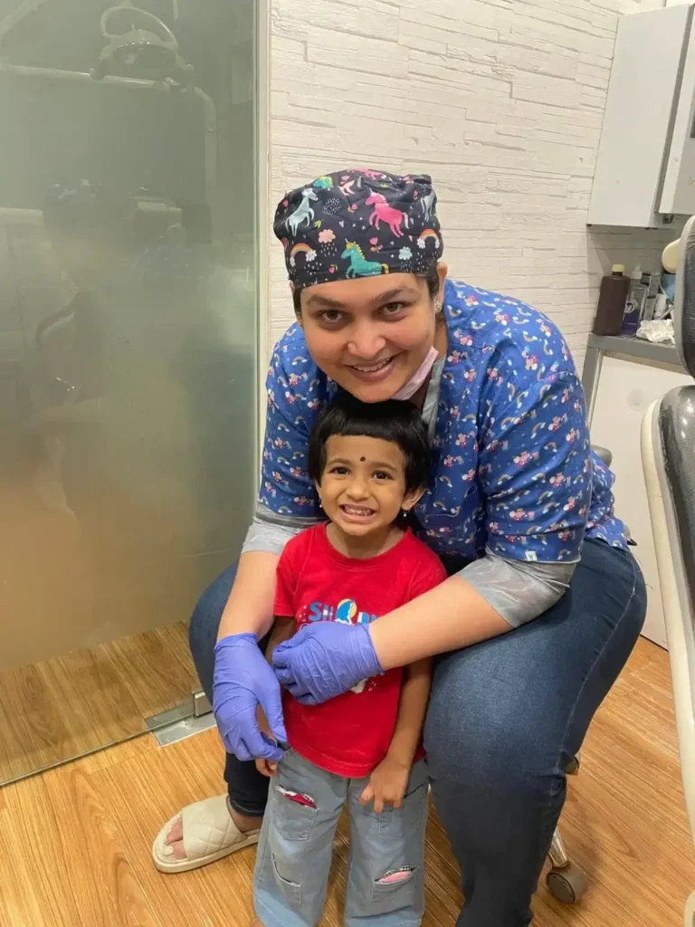 Pediatric dentist in Kandivali treating child with dental care, kids dental, orthodontic aligners.